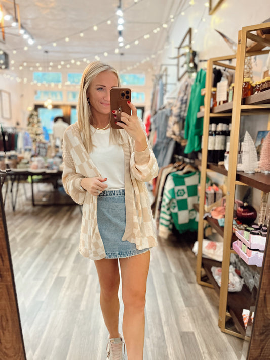 A woman wearing a light weight cardigan.